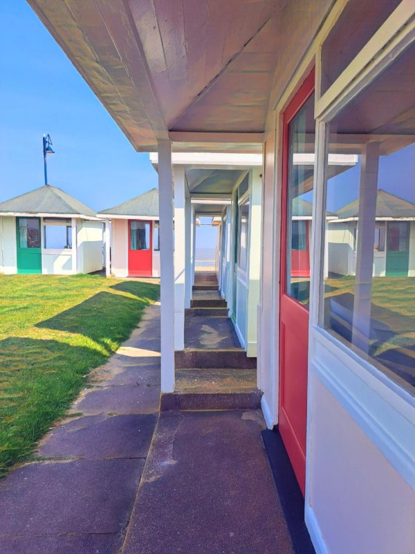 Home From Home by Katharine Plumb (Codling) - 'The huts remind me of my childhood. I grew up in Kent and  they were dotted across the Kent coast, then when I made my  home in Lincolnshire and I discovered the beautiful Lincolnshire  coastline they become a part of my children’s upbringing. They are nostalgic a flash back in time and fast becoming  popular again for another generation to enjoy and some  are being saved from complete ruin.....thank goodness!’  (Mablethorpe)