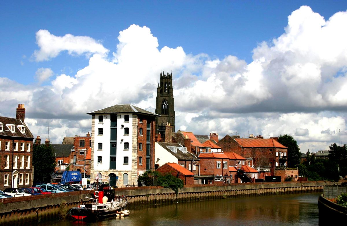 Image of Boston, Lincolnshire which shows a view across the river towards the tower of St Botolph's church.